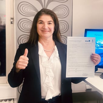 Slavica Djuric is holding the certification document for Porsgrunn. 